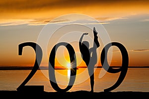 2019 New Year Silhouette of Girl Dancing at Golden Sunset