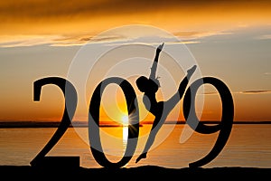 2019 New Year Silhouette of Girl Dancing at Golden Sunset