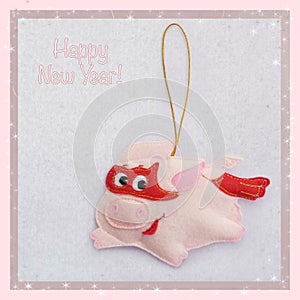 New year. Soft toy made of felt. The cute pig. Christmas tree decoration. The Piglet is flying in a superhero costume. 2019.