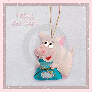 New year. Soft toy made of felt. The cute pig. Piggy`s holding a bag of presents. Christmas tree decoration. Symbol of year. 2019.