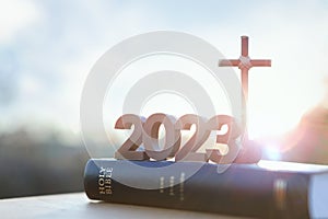 2023 new year sunrise, the cross of Jesus Christ and the Bible