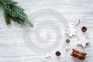 New year symbols. Spruce branch, cones and toys for decoration like spruce and stras on grey background top view space