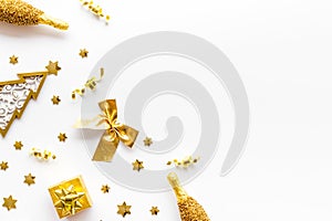 New Year symbols - tree, champagne, decorations - on white background top-down frame copy space