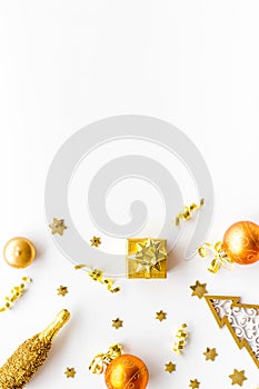 New Year symbols - tree, champagne, decorations - on white background top-down frame copy space