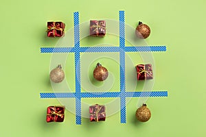 New Year tic tac toe game, isolated on green background. Christmas, winter concept.