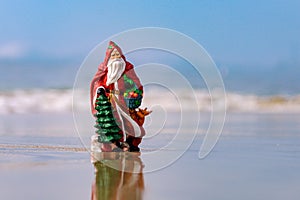 New Year travel. Toy summer Santa. Christmas vacation background, banner, poster or greeting cards.