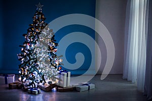 New year tree on Christmas garlands on blue blue white background