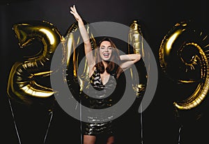 New Year. Woman With Balloons Celebrating At Party. Portrait Of Beautiful Smiling Girl In Shiny Dress Throwing Confetti