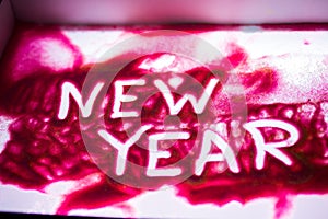 `New Year` word on pink sand