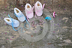 2023 new year written laces of children`s shoes and pacifier on old wooden background. Top view. Flat lay. Space for text