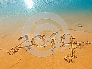 New Year 2014 written in sand on the beach