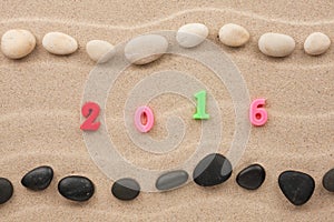 New year 2016 written on the sand among stones