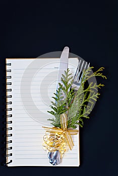 New Year resolutions, flat lay shot from above with the handwritten words and copy space, on a dark blue background