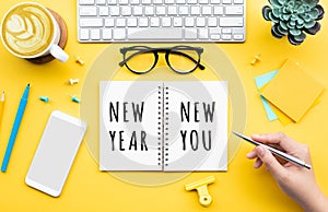 New year new you concepts with person writing text on notepaper