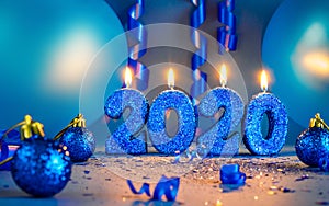 New years 2020 blue glitter candals with balloons and streamers