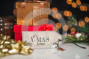 New years and christmas deco, written its xmas time on wooden desk