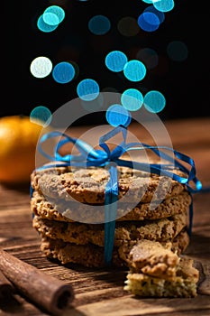 New Years Christmas wrapping of oatmeal cookies beautifully tied with a blue ribbon, close-up.