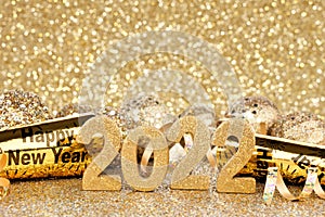 New Years Eve 2022 gold decorations with twinkling background