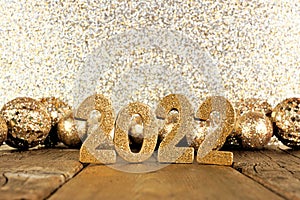 New Years Eve 2022 golden decorations with twinkling background