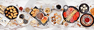 New Years Eve appetizer table scene. Above view on a white wood banner background.