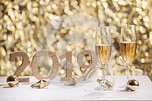 New Years Eve celebration background with pair of flutes, bottle