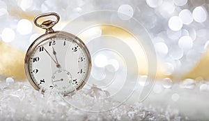 New Years eve countdown. Minutes to midnight on an old watch, bokeh festive