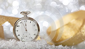 New Years eve countdown. Minutes to midnight on an old watch, bokeh festive