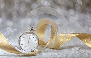 New Years eve party celebration. Minutes to midnight on an old fashioned watch, bokeh festive