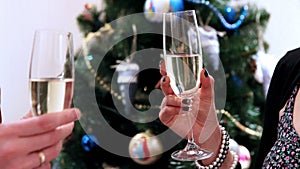 A New Years footage: two glasses of champagne clink as a couple celebrates