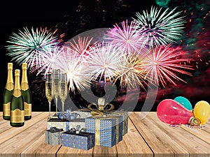 New years party table with champagne drinks gifts balloons and fire works background