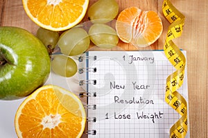 New years resolutions written in notebook and tape measure