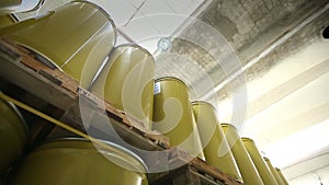 New yellow barrels inside a storage warehouse.