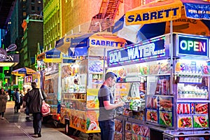 New York, Broadway at night. Take away fast food kiosks selling hot dog