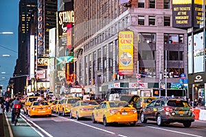 New York, Broadway streets at night. Colorful neon lights, ads and people walking