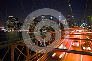 New York Brooklyn Bridge at night with taxis