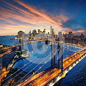 New York City - beautiful sunset over manhattan with manhattan and brooklyn bridge photo