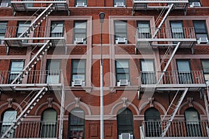 New York City building with fire escapes and a lampost