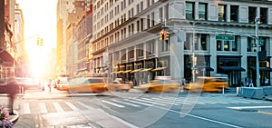 New York City - Busy intersection with yellow taxis speeding through the crowded intersection of 5th Avenue and 23rd Street with