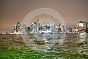 NEW YORK CITY - DECEMBER 6, 2018: Lower Manhattan skyline and Brooklyn Bridge at night
