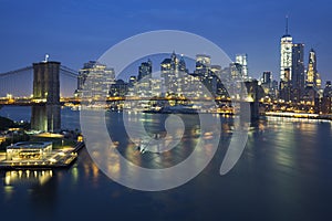 New York City at dusk with Brooklyn Bridge.