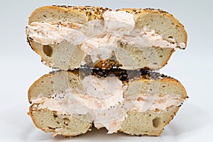 New York City Everything Bagel Cut in Half and Filled with Lox Spread Cream Cheese on a White Plate