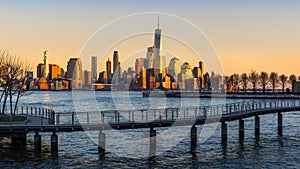 New York City Financial District skyscrapers and Hudson River at sunset