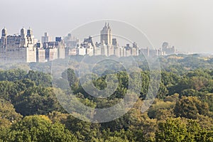 New York City foggy panoramic landscape view of the historic buildings of the Upper West Side towering above the trees of Central