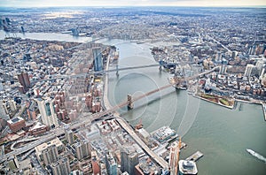 New York City from helicopter point of view. Brooklyn, Manhattan and  Williamsburg Bridges with Manhattan skyscrapers on a cloudy