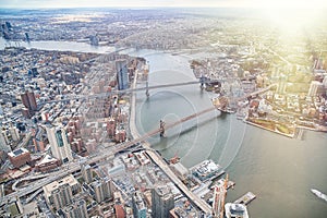 New York City from helicopter point of view. Brooklyn, Manhattan and  Williamsburg Bridges with Manhattan skyscrapers on a cloudy