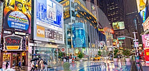 NEW YORK CITY - JUNE 13, 2013: Tourists enjoy night life in Times Square. New York attracts 50 million people from all over the