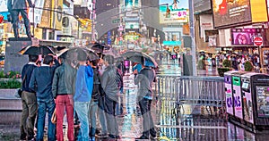 NEW YORK CITY - JUNE 13, 2013: Tourists enjoy night life in Times Square. New York attracts 50 million people from all over the