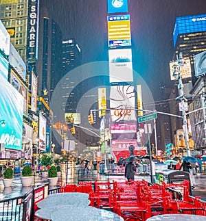 NEW YORK CITY - JUNE 13, 2013: Tourists enjoy night life in Times Square. New York attracts 50 million people from all over the