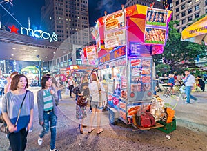 NEW YORK CITY - JUNE 8, 2013: Tourists and locals near street food vendor. New York is visited by more than 50 million people ann
