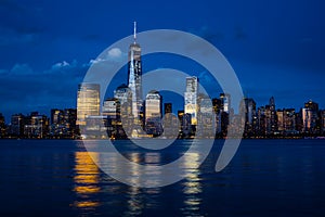 New York City Manhattan downtown skyline with skyscrapers illuminated over Hudson River panorama